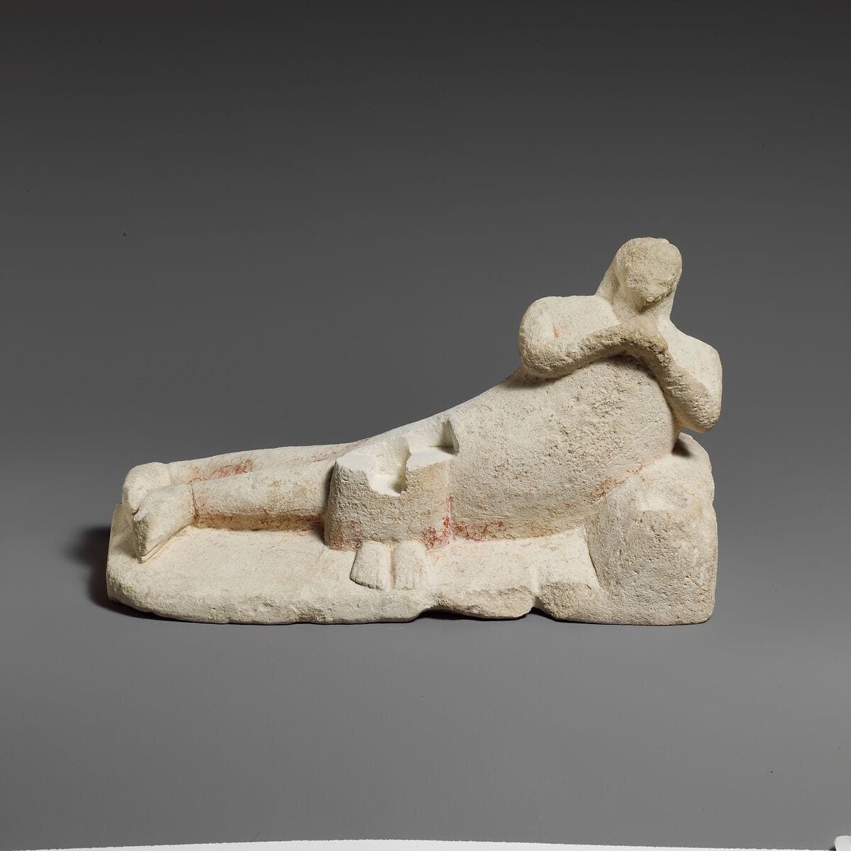 Limestone group of a male banqueter and a woman, Archaic II Cypriot statue